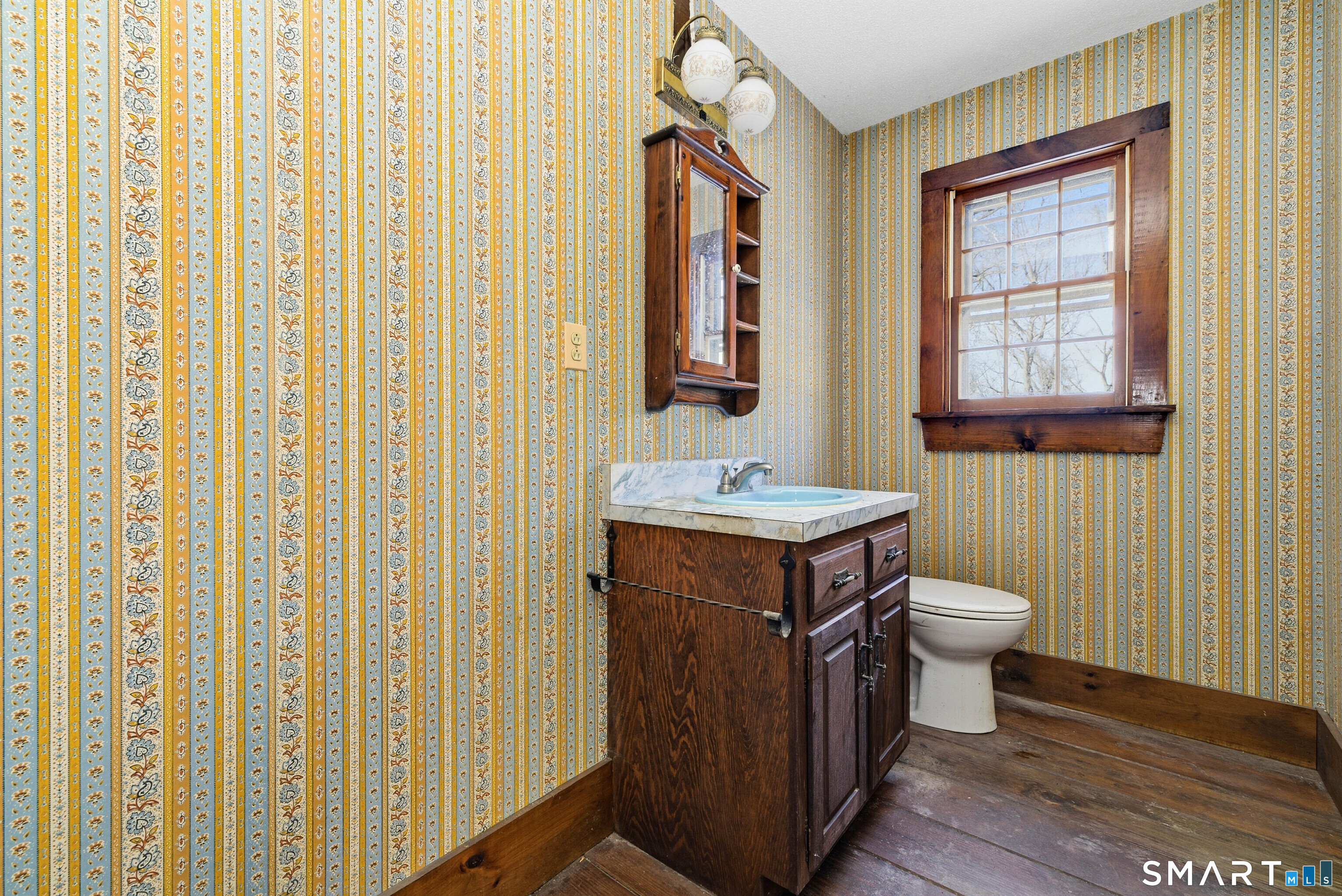 115 Melrose Road East Windsor, CT 06016 - Photo 14 of 28 a bathroom with a sink a toilet and a mirror