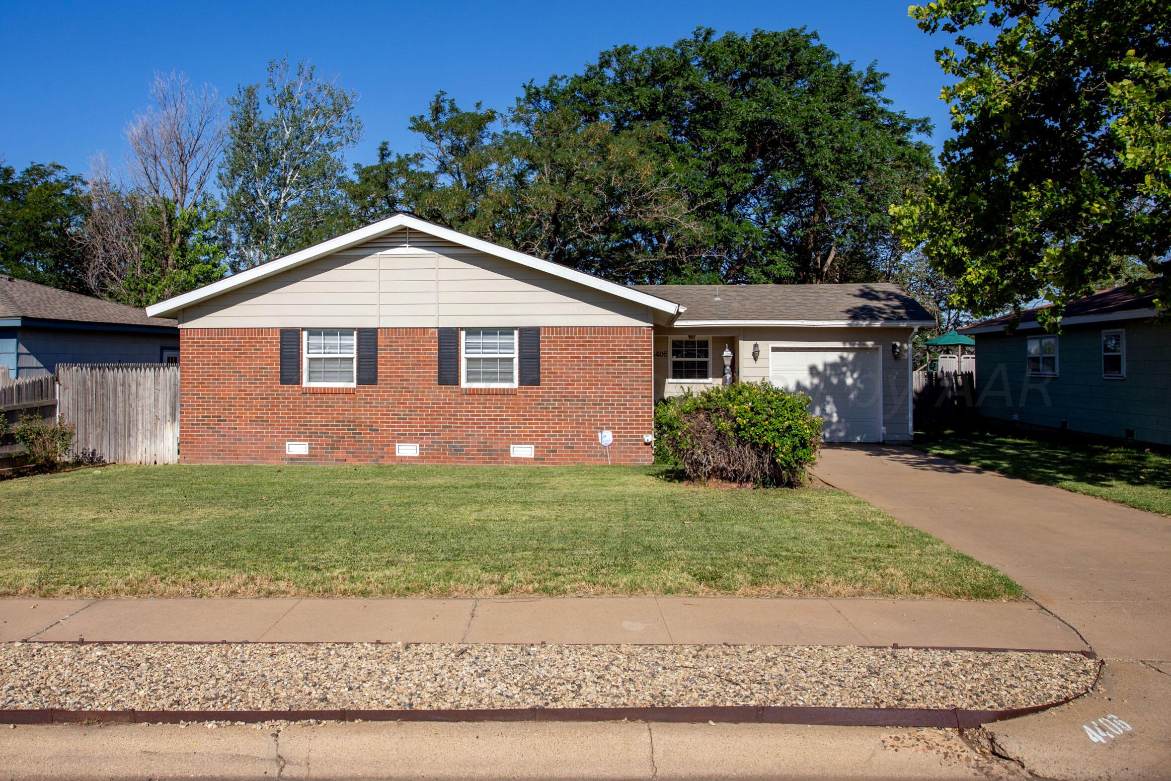 4406 South Bonham Street Amarillo, TX 79110 - Photo 1 of 26 a front view of a house with a yard and garage
