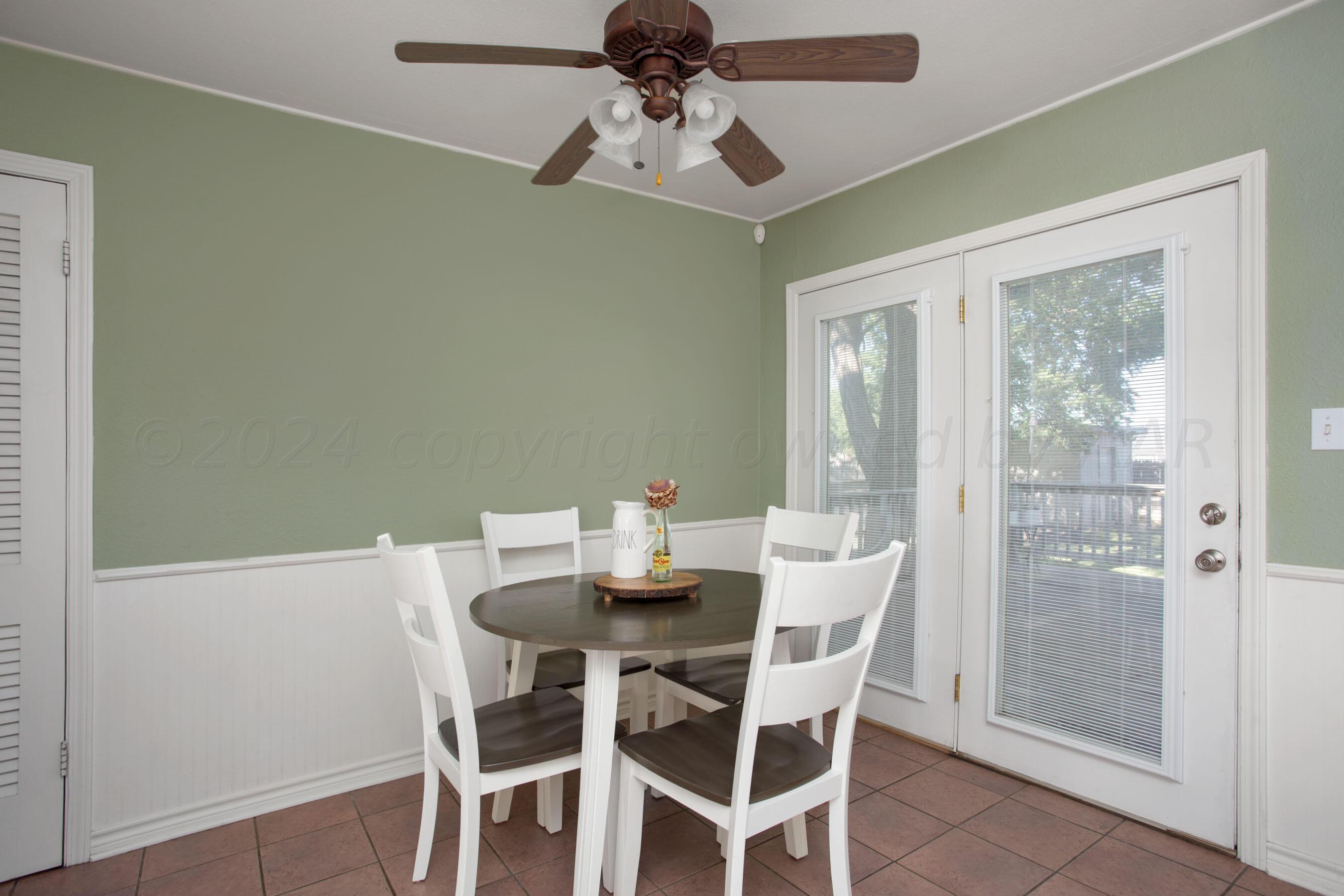 4406 South Bonham Street Amarillo, TX 79110 - Photo 11 of 26 a view of a dining room with furniture wooden floor and chandelier