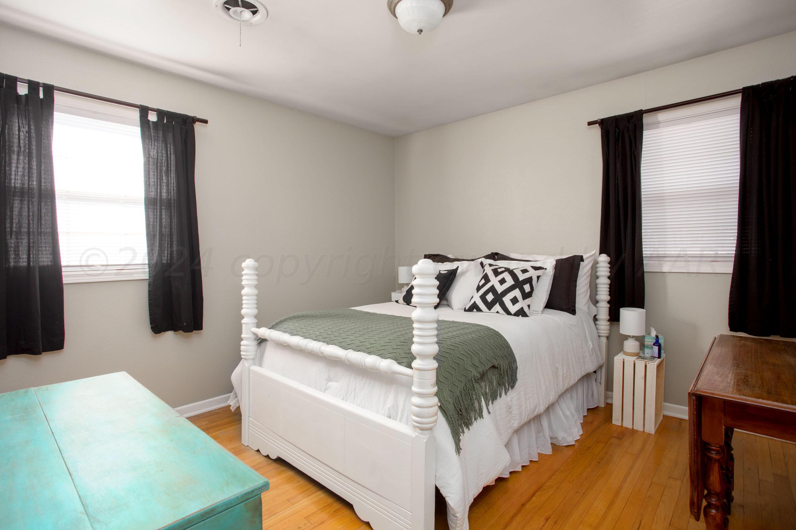 4406 South Bonham Street Amarillo, TX 79110 - Photo 16 of 26 a bedroom with a bed and wooden floor