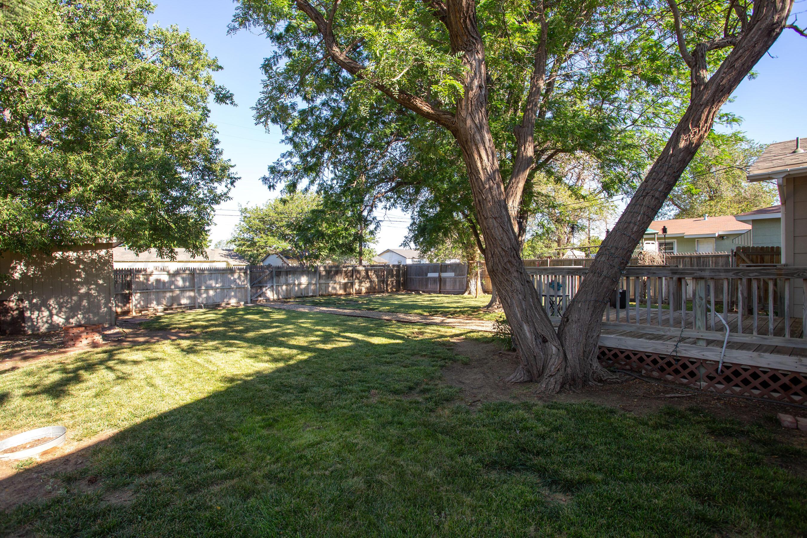 4406 South Bonham Street Amarillo, TX 79110 - Photo 22 of 26 a view of a yard with large trees and a barn