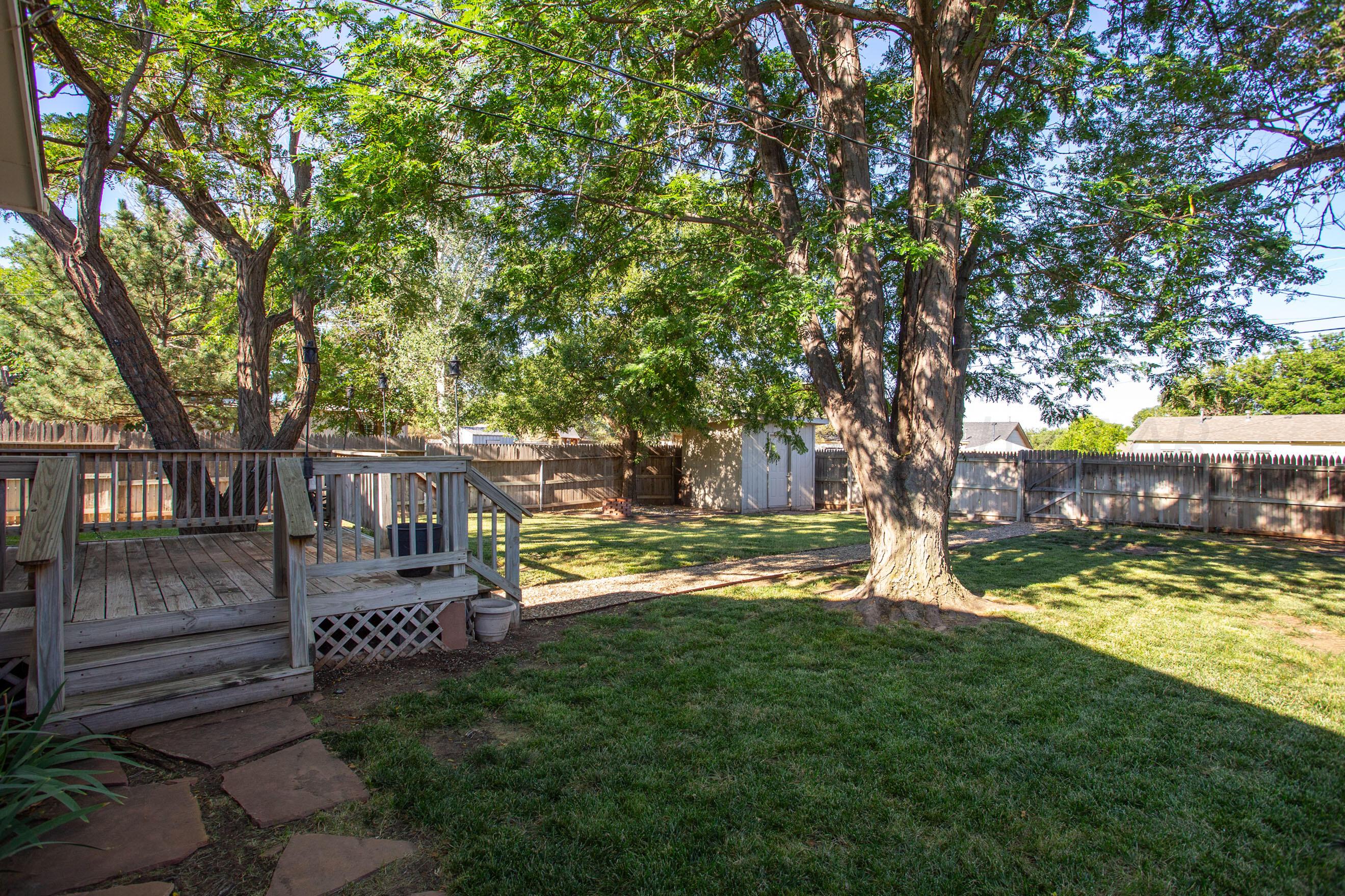 4406 South Bonham Street Amarillo, TX 79110 - Photo 26 of 26 a view of a backyard with wooden fence and a large tree