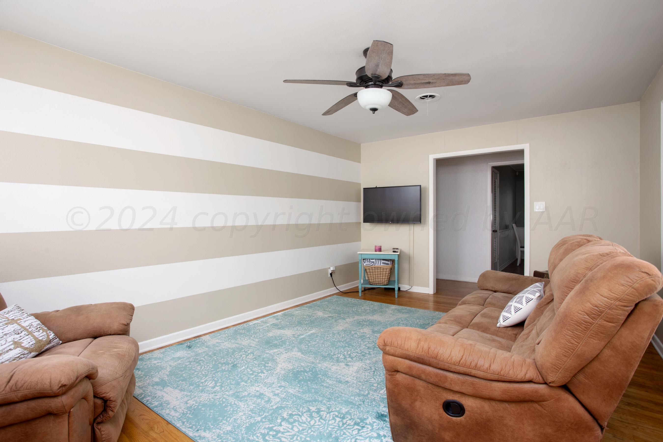4406 South Bonham Street Amarillo, TX 79110 - Photo 6 of 26 a living room with furniture and a flat screen tv