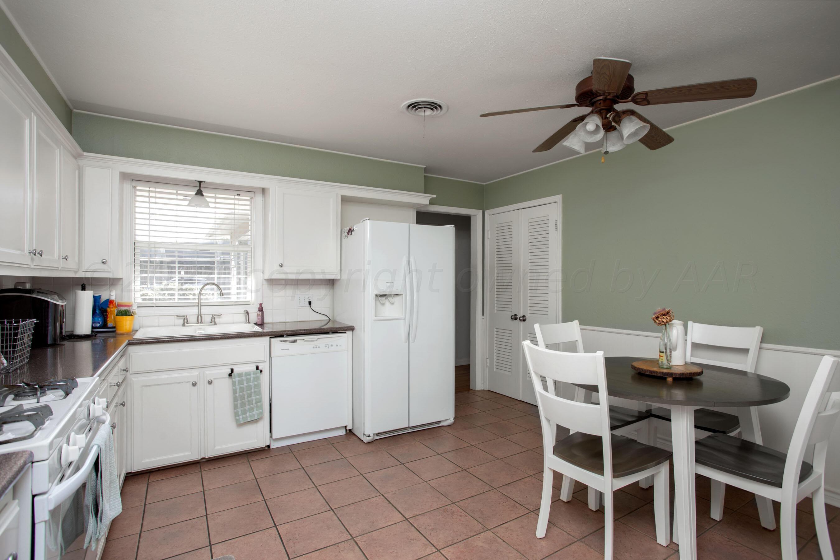 4406 South Bonham Street Amarillo, TX 79110 - Photo 7 of 26 a kitchen with a dining table chairs and white appliances
