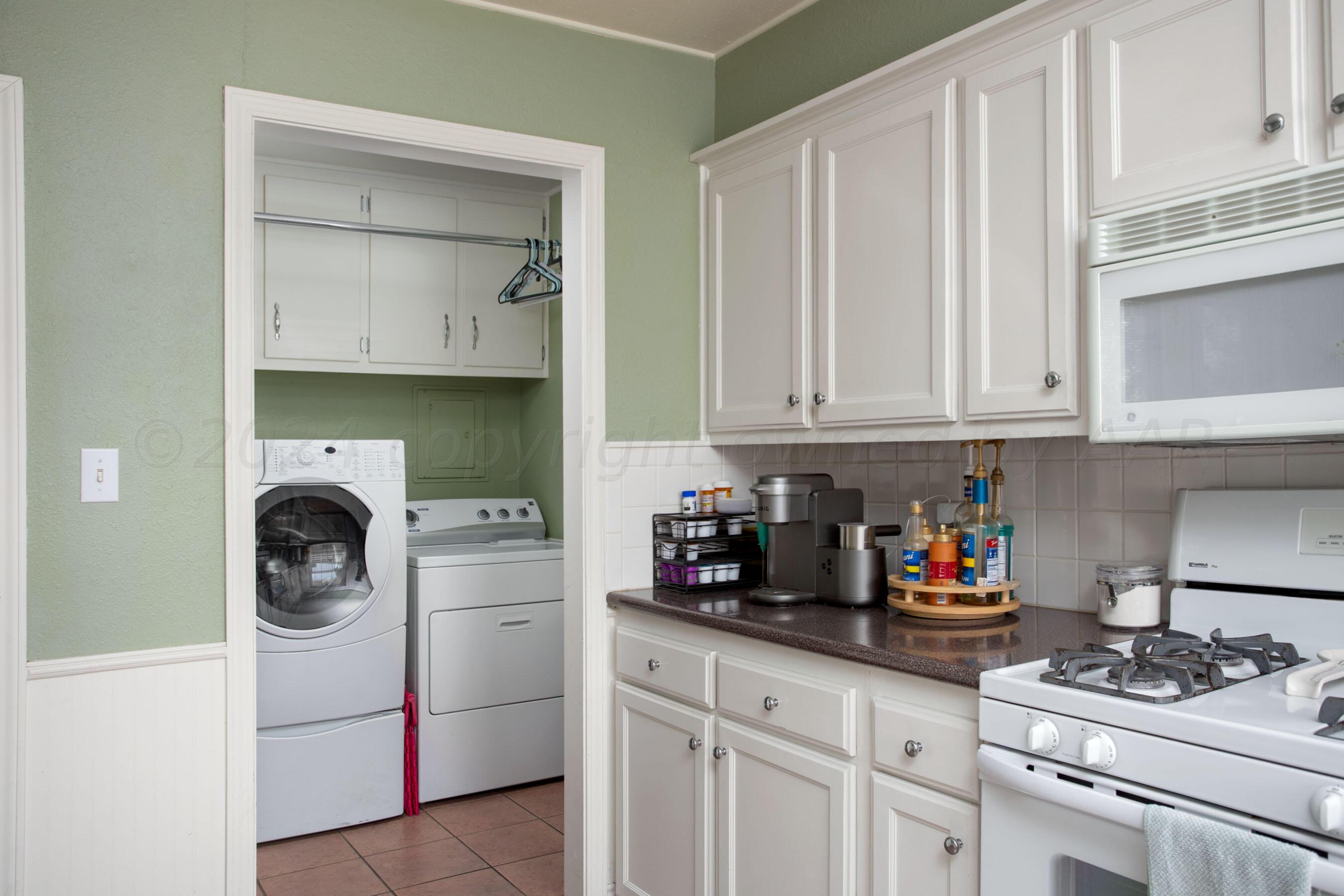 4406 South Bonham Street Amarillo, TX 79110 - Photo 8 of 26 a kitchen with white cabinets and sink