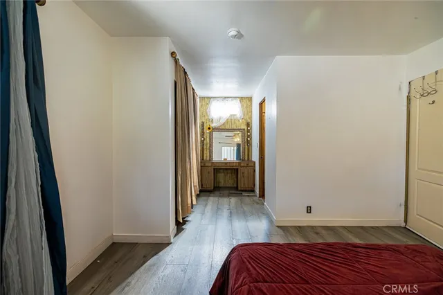 a view of bedroom with furniture and wooden floor
