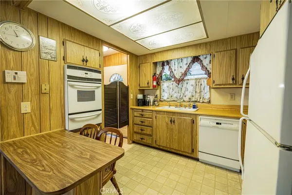 a kitchen that has a table and chairs in it