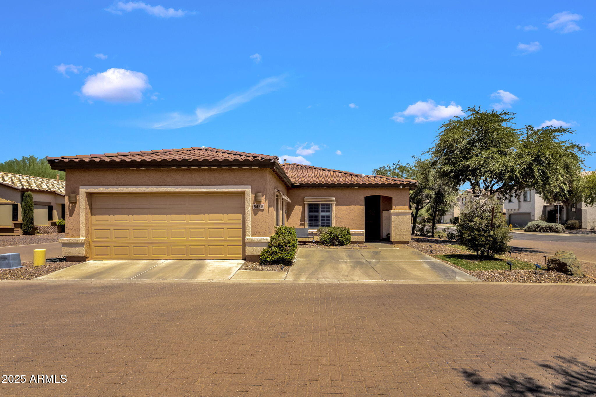 a view of a house with a patio and a yard