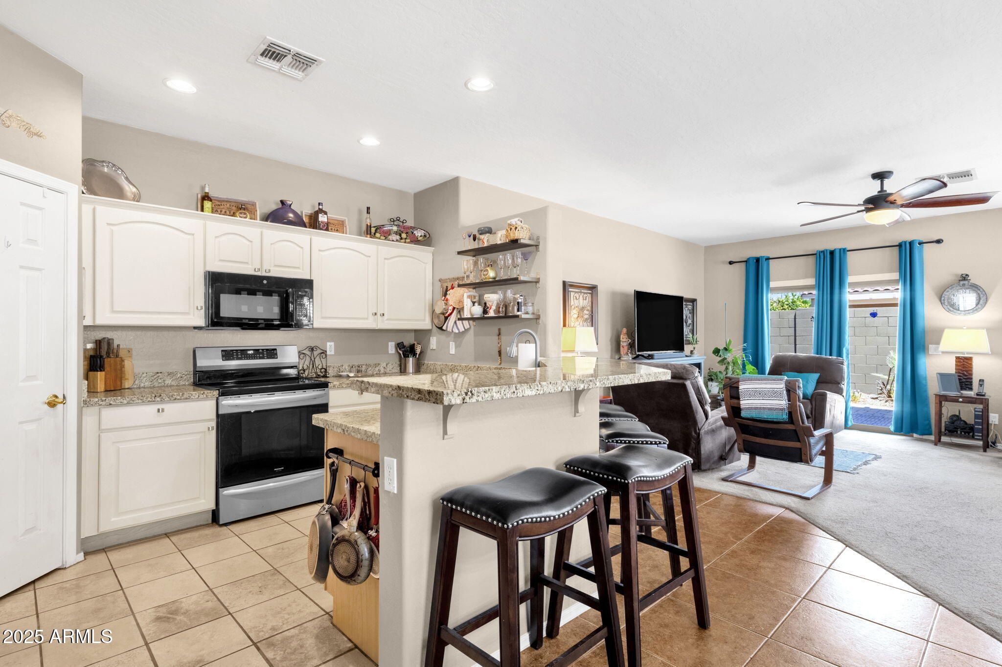 6456 South Nash Way Chandler, AZ 85249 - Photo 13 of 57 a kitchen with cabinets and chairs
