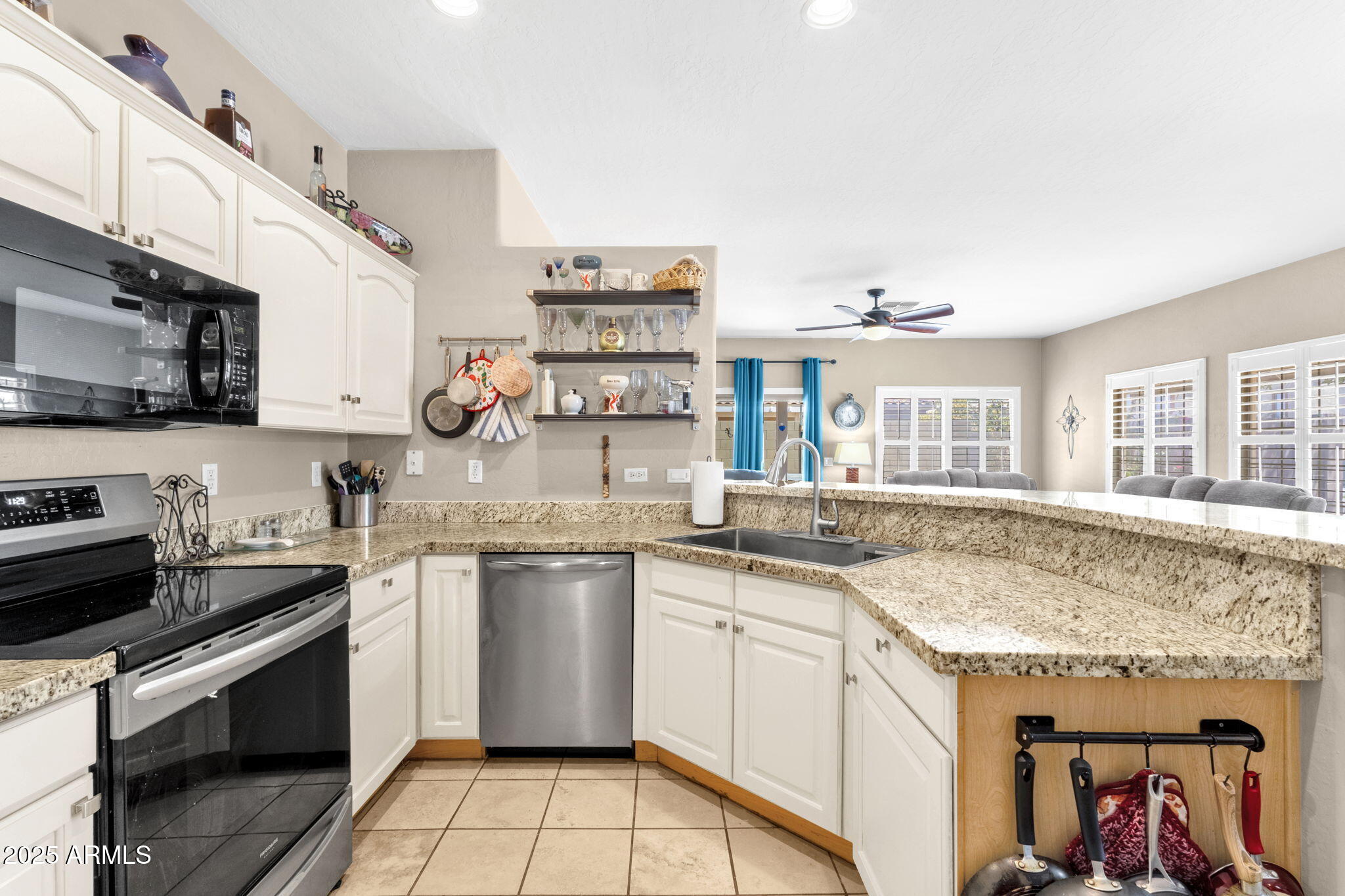 6456 South Nash Way Chandler, AZ 85249 - Photo 16 of 57 a kitchen with stainless steel appliances granite countertop a sink and stove top oven