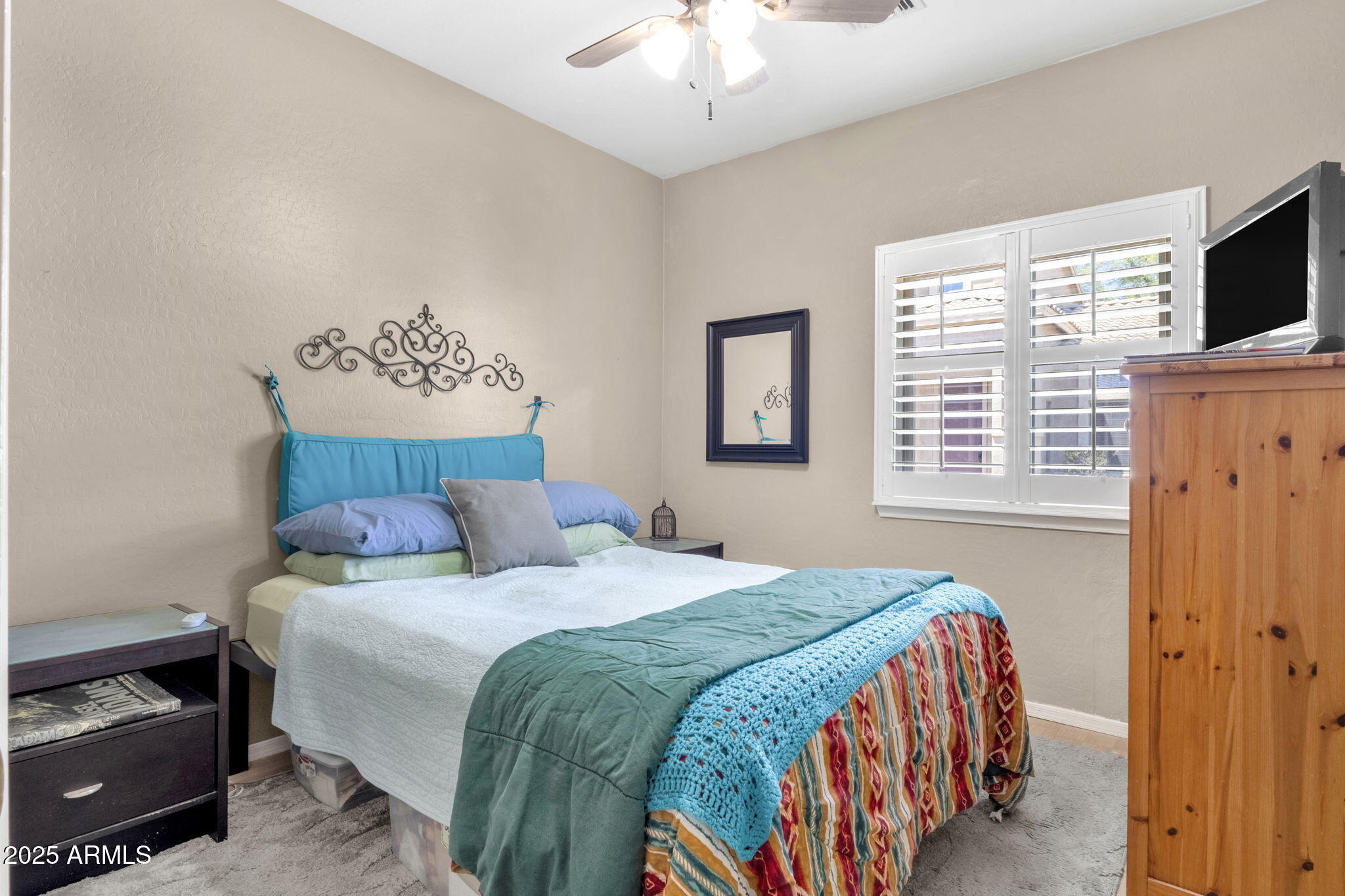 6456 South Nash Way Chandler, AZ 85249 - Photo 25 of 57 a bedroom with a bed and a chandelier