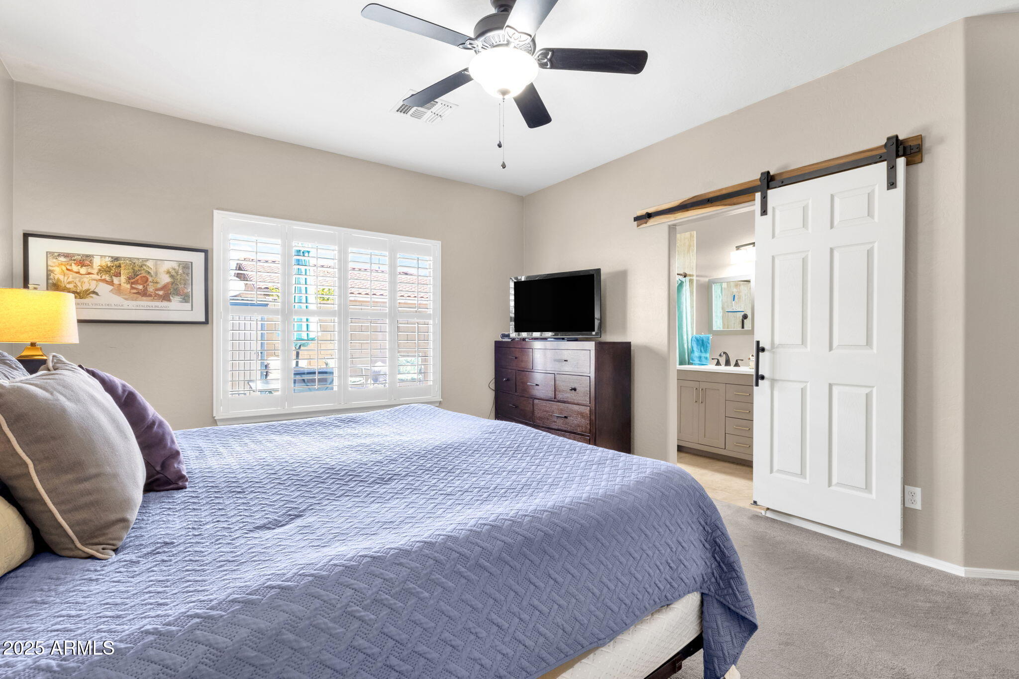 6456 South Nash Way Chandler, AZ 85249 - Photo 29 of 57 a spacious bedroom with a bed and a flat screen tv