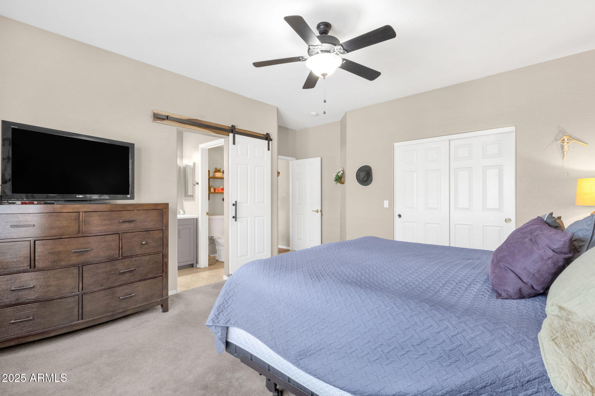 6456 South Nash Way Chandler, AZ 85249 - Photo 30 of 57 a bedroom with a bed and a flat screen tv