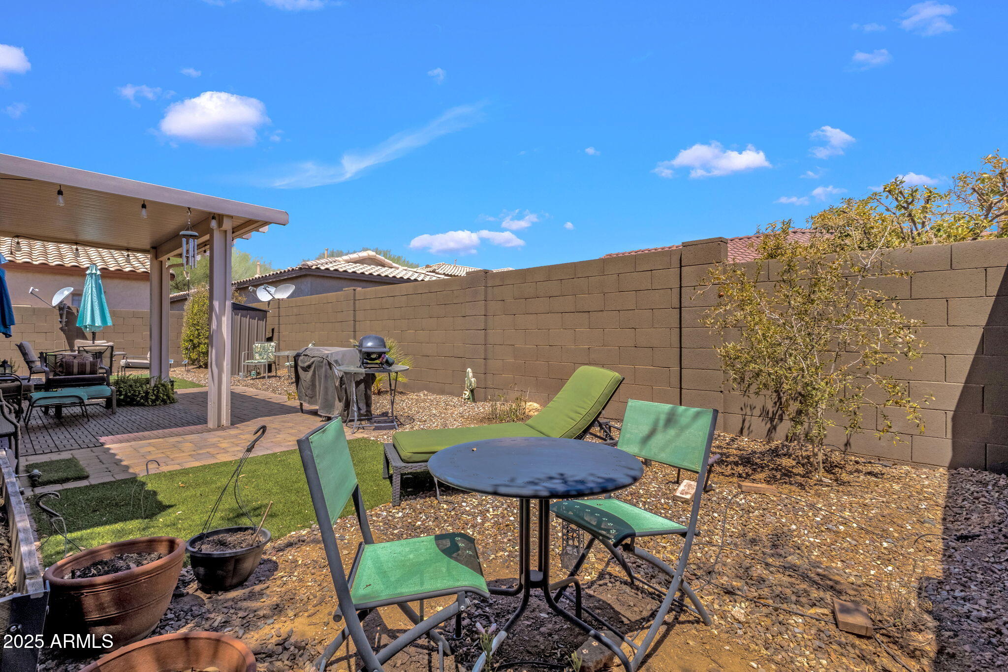 6456 South Nash Way Chandler, AZ 85249 - Photo 35 of 57 a view of a chairs and table in backyard