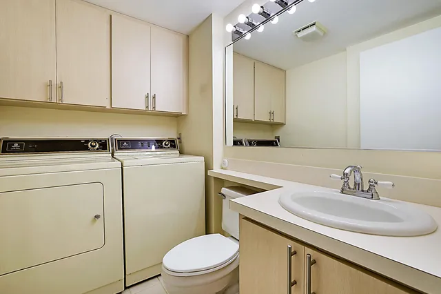 a bathroom with a sink a toilet and vanity