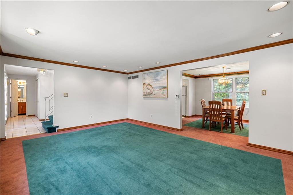 110 Atterbury Road Monroeville, PA 15146 - Photo 9 of 36 a view of an empty room with window and wooden floor