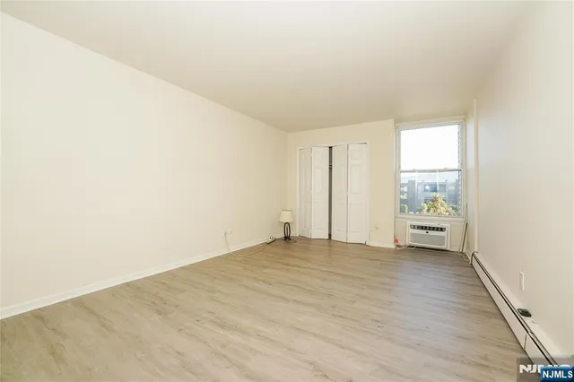 a view of an empty room and a window