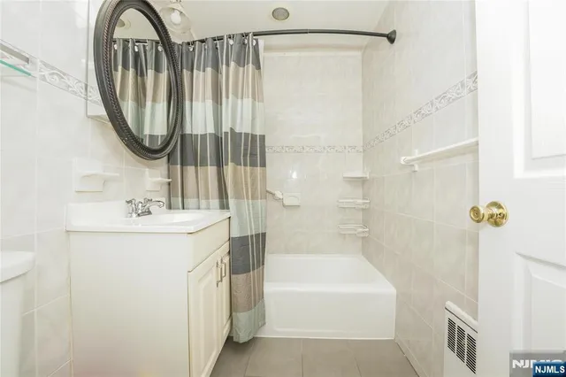 a bathroom with a sink a mirror and a bathtub