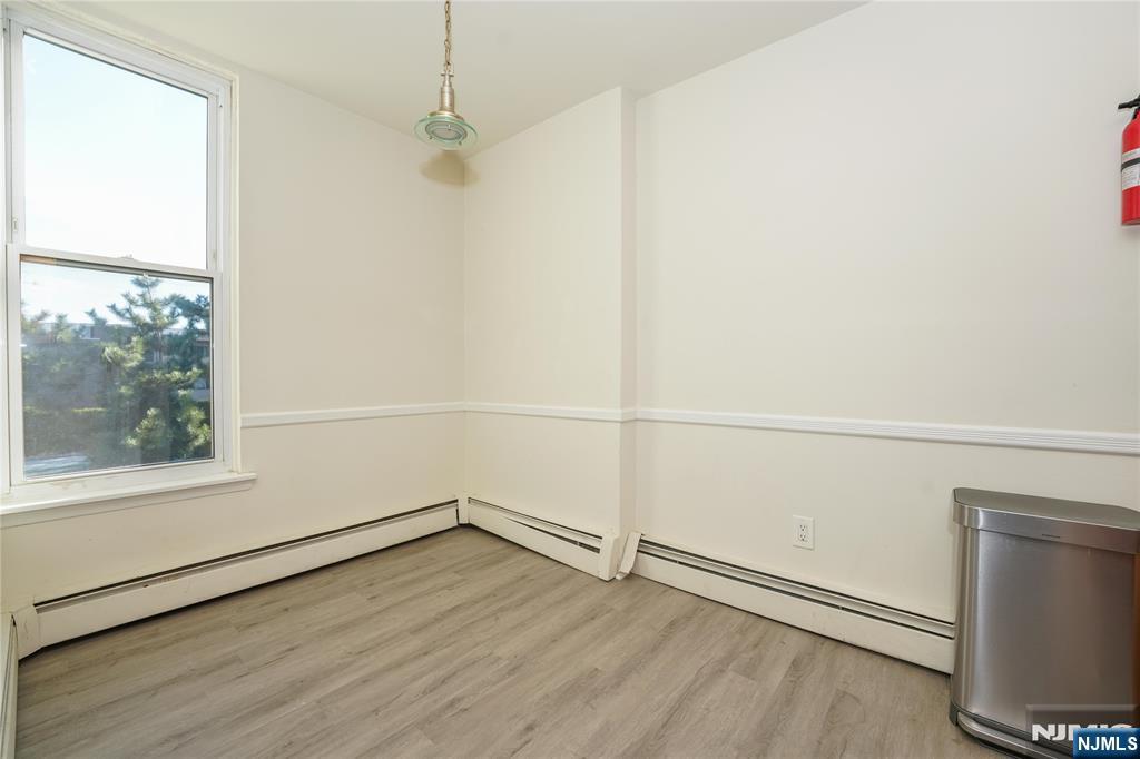 1 River, Unit 3G Nutley, NJ 07110 - Photo 10 of 25 an empty room with wooden floor and windows