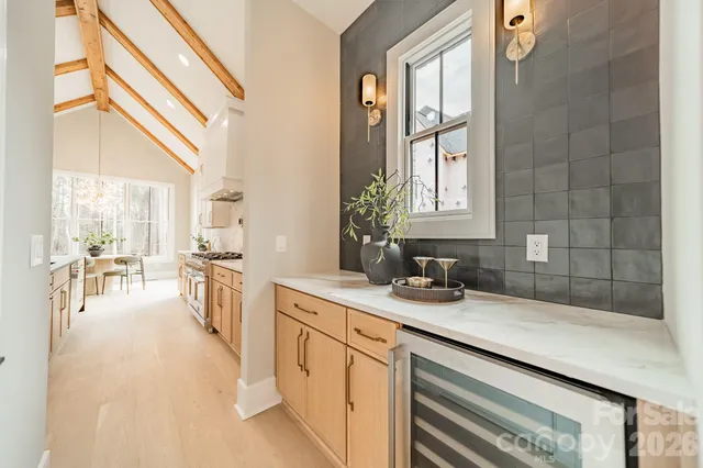 a large white kitchen with a large window