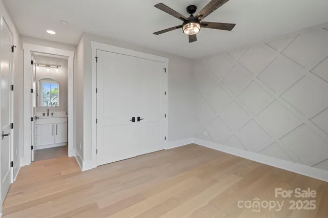 an empty room with fan and entrance