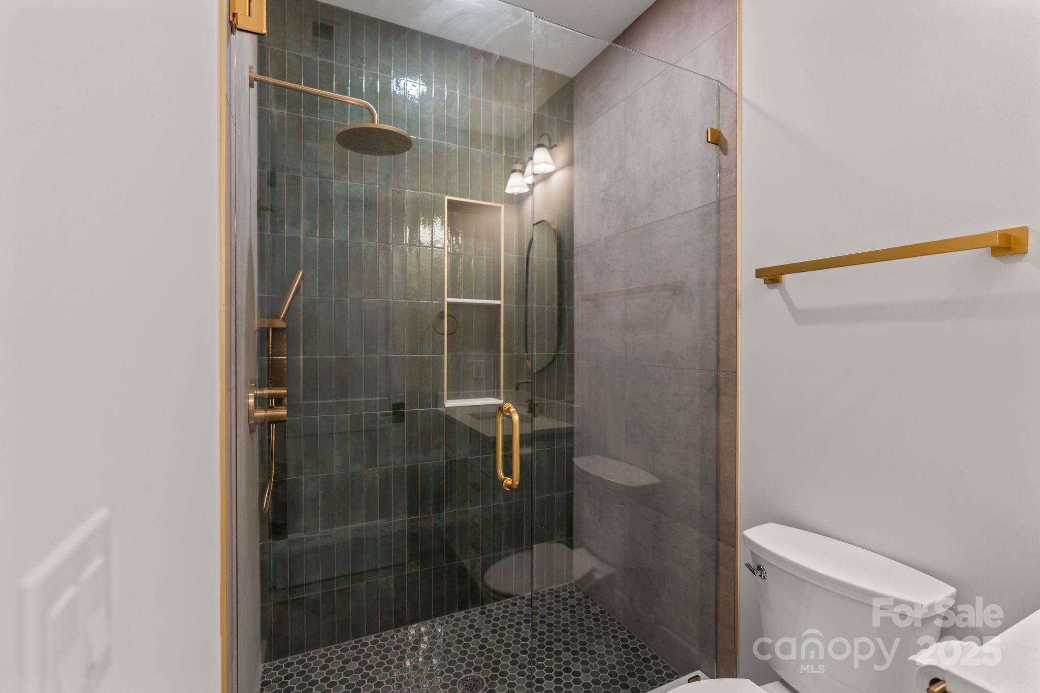 6805 Weddington Matthews Road Weddington, NC 28104 - Photo 20 of 23 a bathroom with a shower a toilet and sink