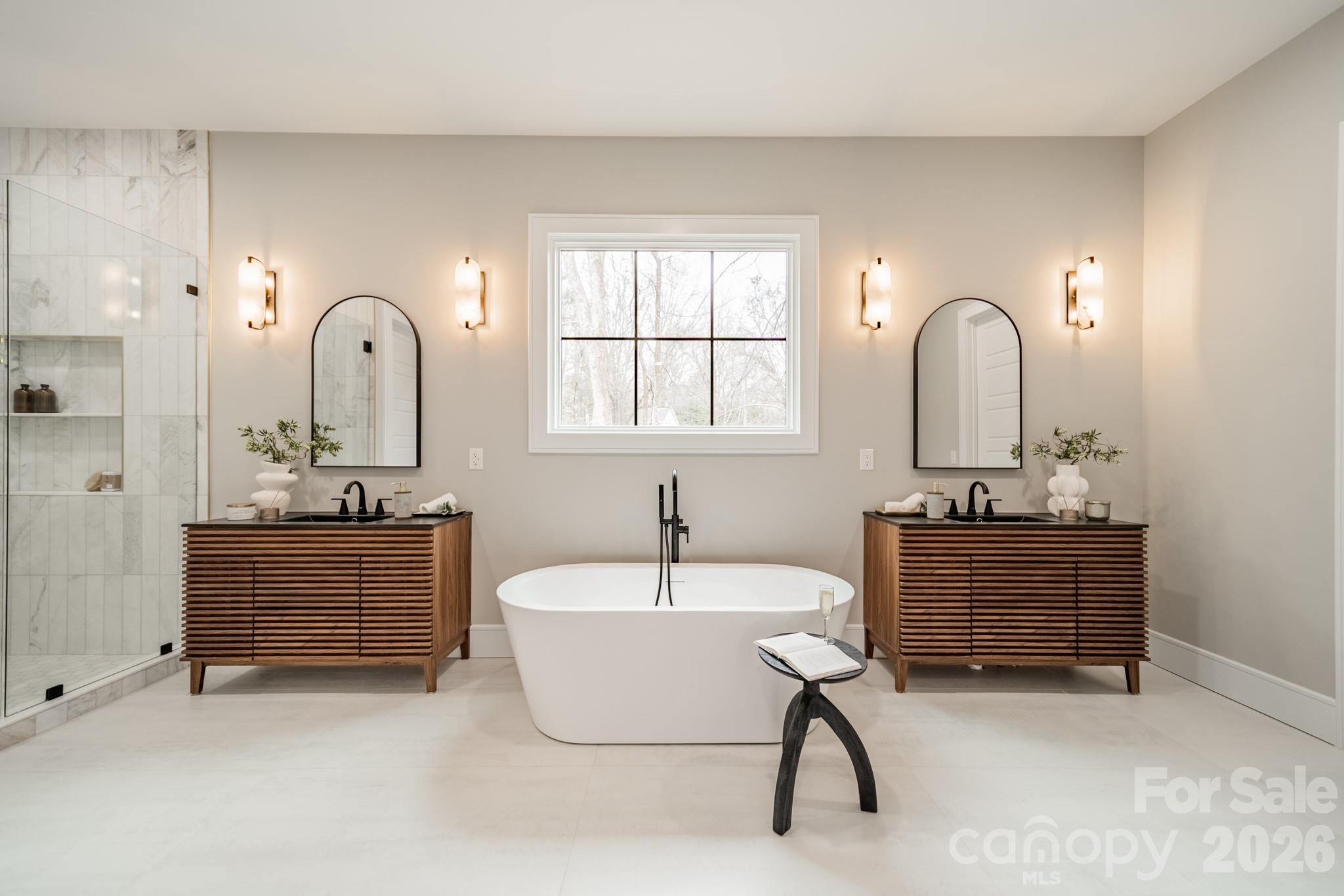6805 Weddington Matthews Road Weddington, NC 28104 - Photo 21 of 38 a bathroom with a tub sink and mirror