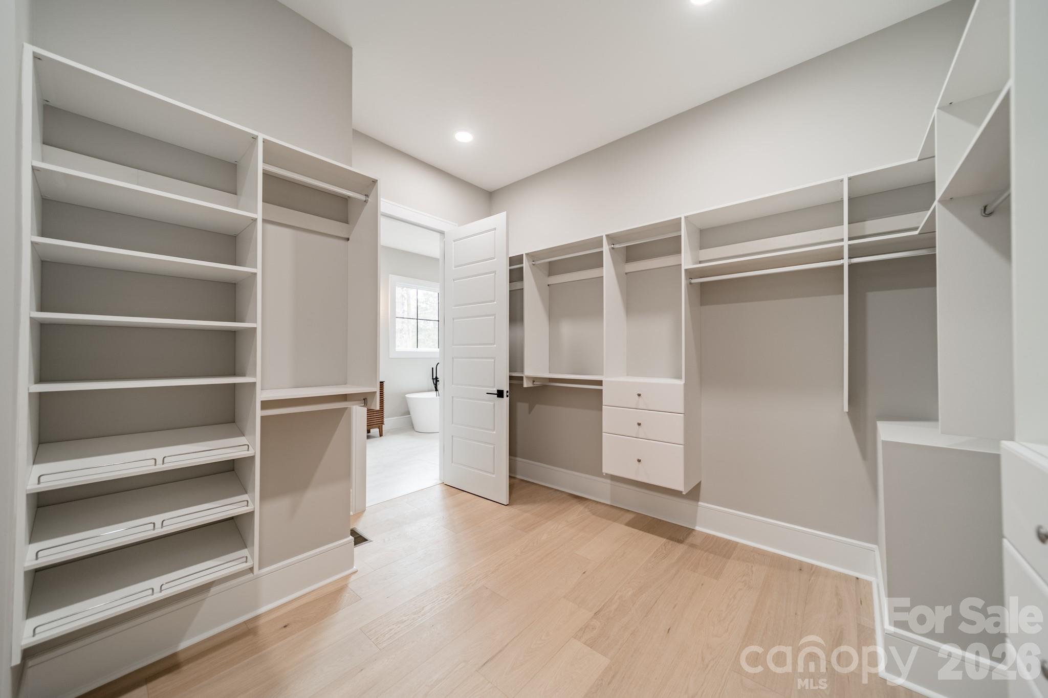 6805 Weddington Matthews Road Weddington, NC 28104 - Photo 22 of 38 a view of walk in closet with empty racks