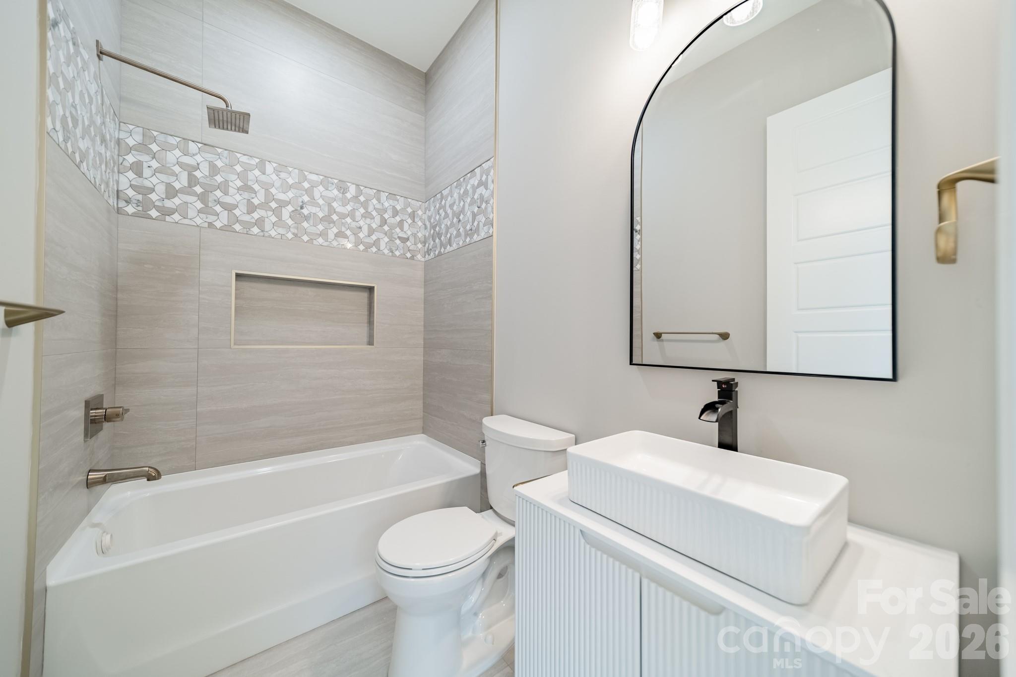 6805 Weddington Matthews Road Weddington, NC 28104 - Photo 24 of 38 a bathroom with a sink a toilet and bathtub