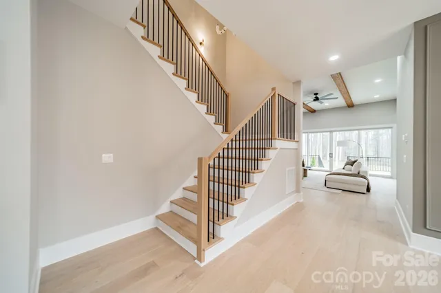 a living room with furniture a rug and a window