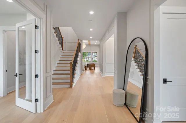a view of a hallway view with wooden floor and staircase