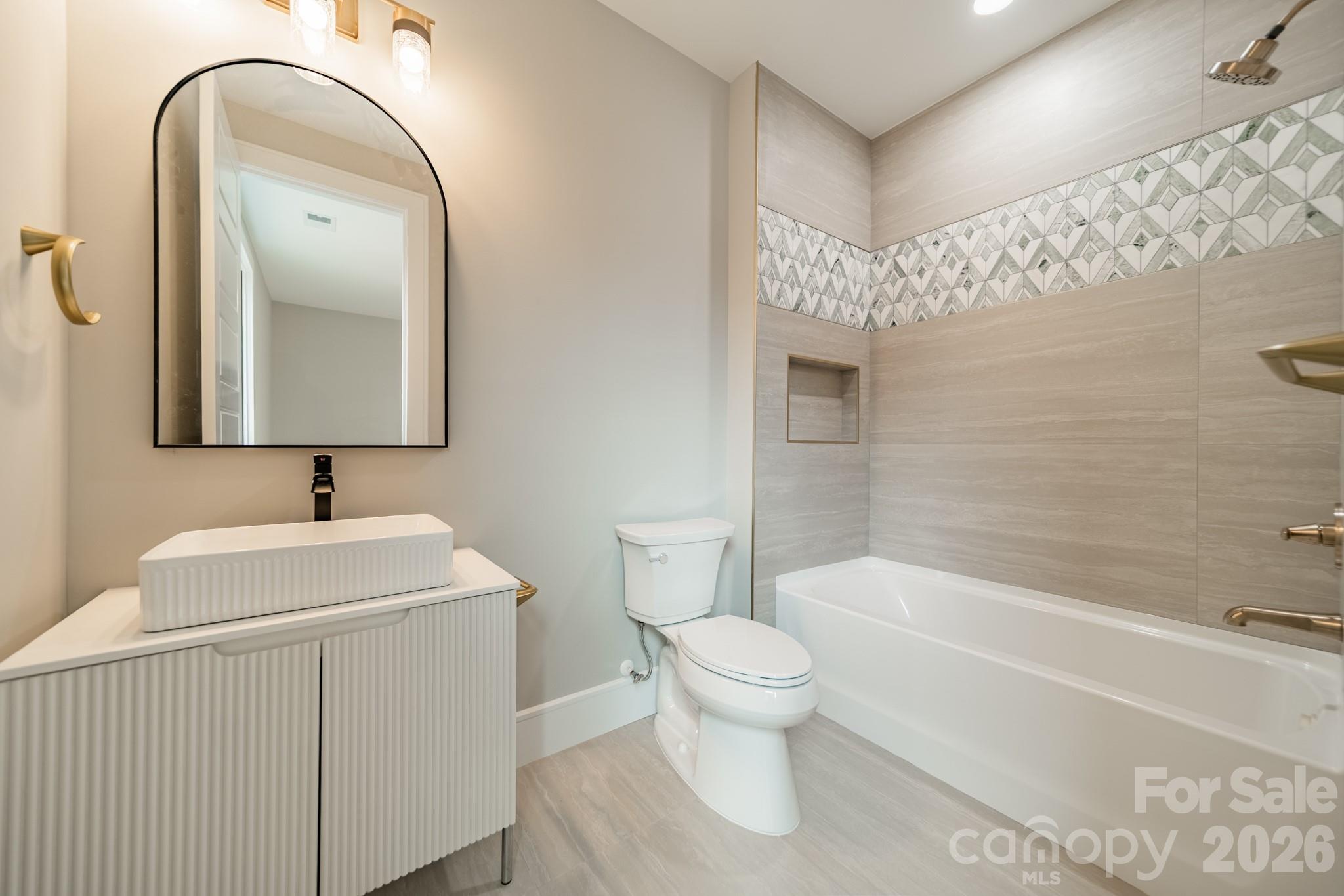 6805 Weddington Matthews Road Weddington, NC 28104 - Photo 33 of 38 a bathroom with a toilet sink and mirror