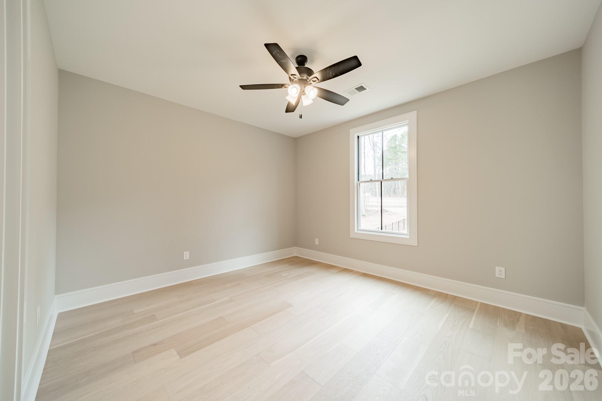 6805 Weddington Matthews Road Weddington, NC 28104 - Photo 34 of 38 an empty room with window and ceiling fan
