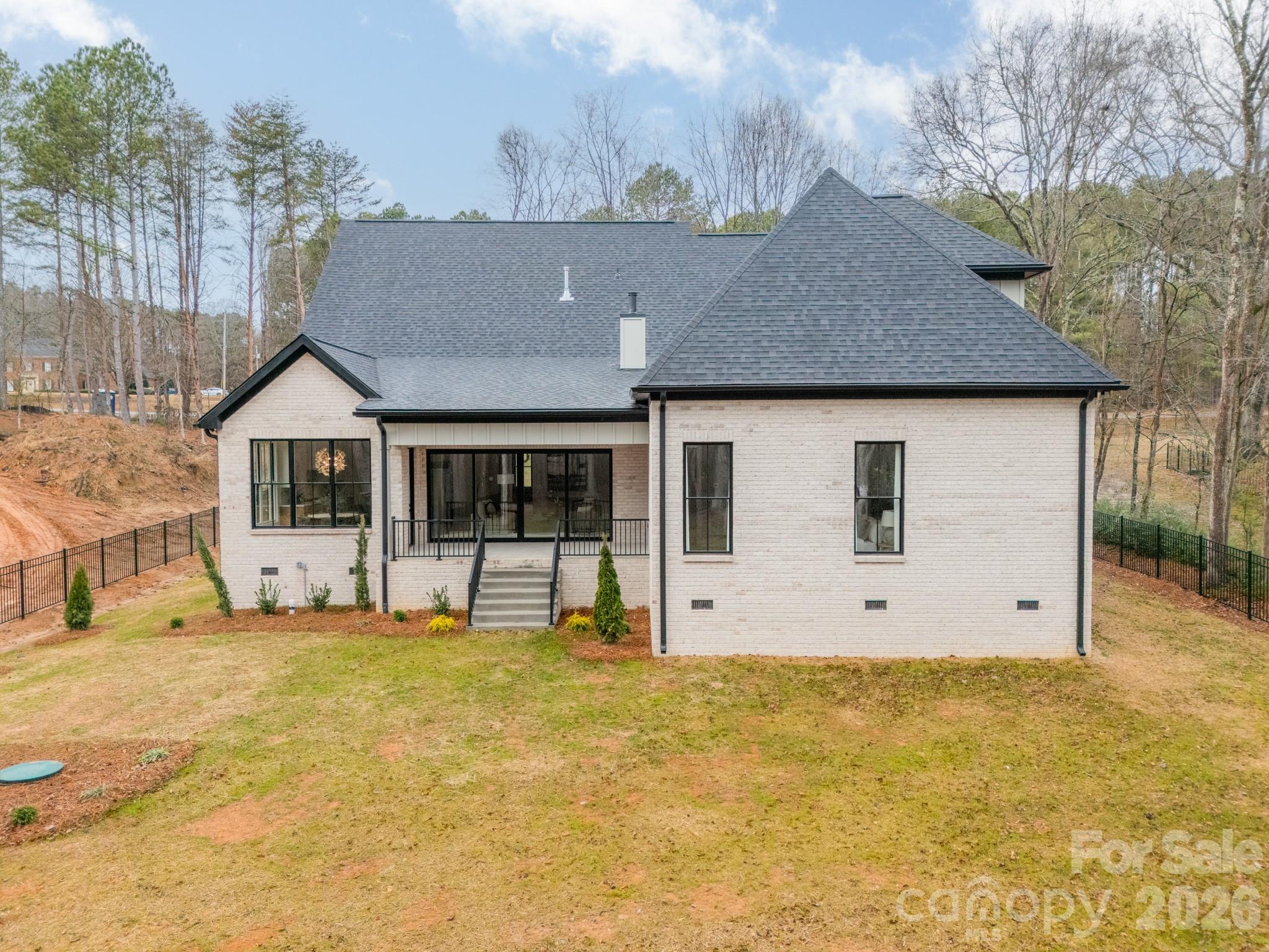 6805 Weddington Matthews Road Weddington, NC 28104 - Photo 4 of 38 a front view of a house with a yard and garage