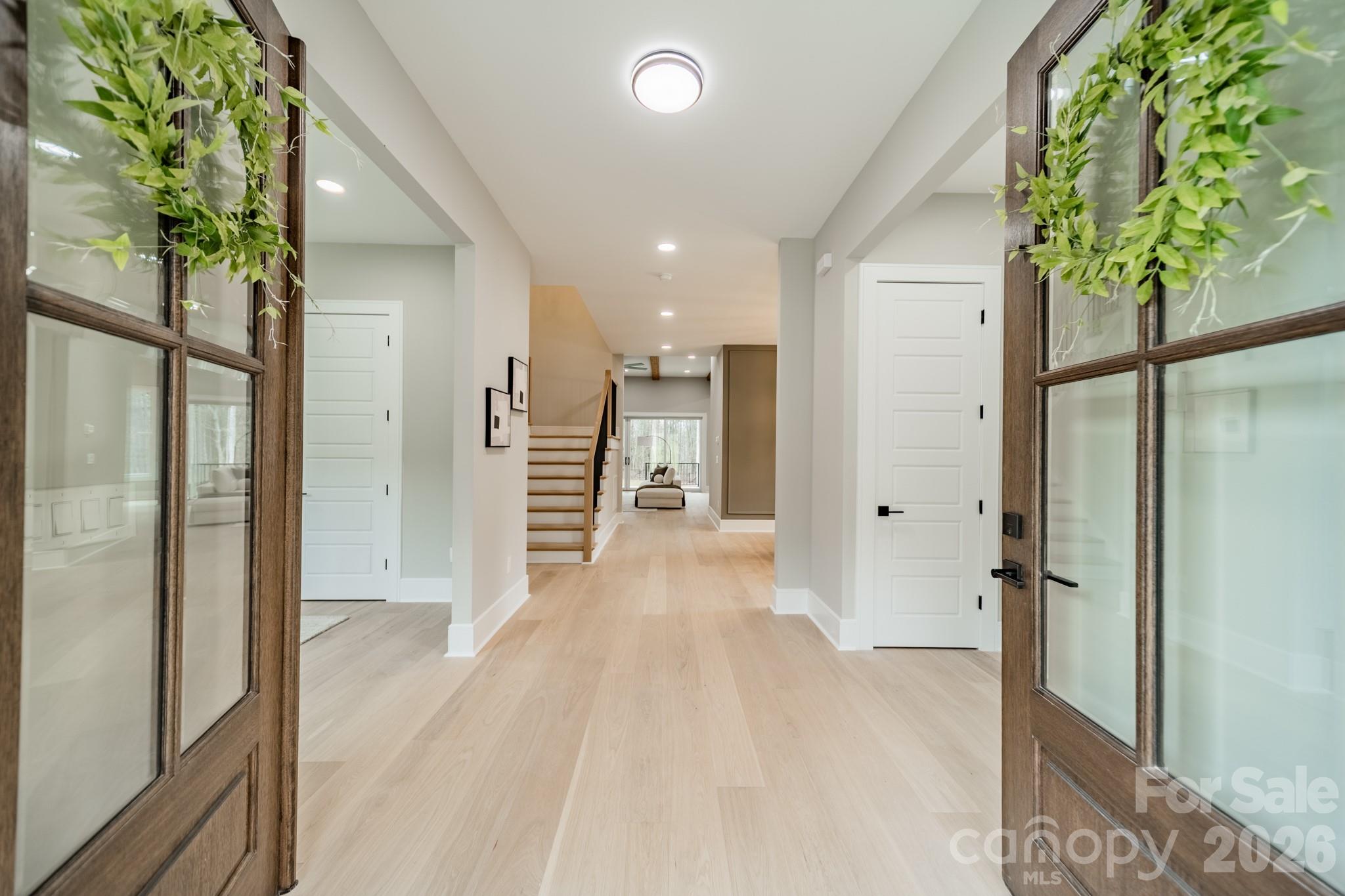 6805 Weddington Matthews Road Weddington, NC 28104 - Photo 7 of 38 a view of a hallway with wooden floor and windows