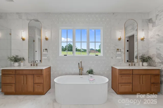 a bathroom with a double vanity sink mirror and bathtub