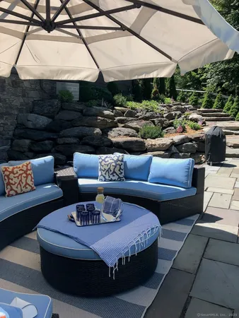 a outdoor space with patio lots of furniture and umbrella