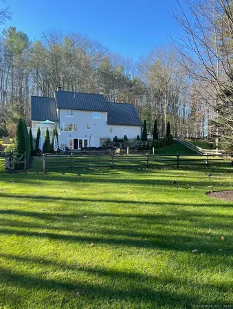 a front view of a house with a yard table and chairs
