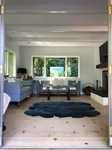 a living room with furniture window and a table