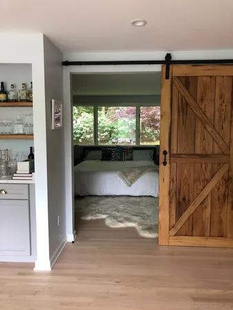 a view of entryway with a floor to ceiling window and wooden floor
