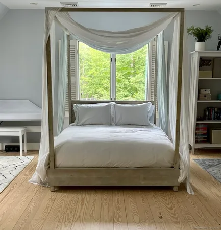a bedroom with a bed and a fireplace