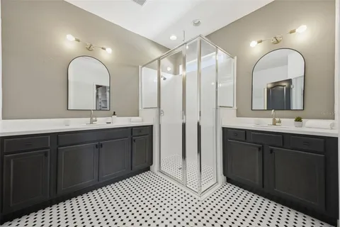 a bathroom with a double vanity sink and mirror