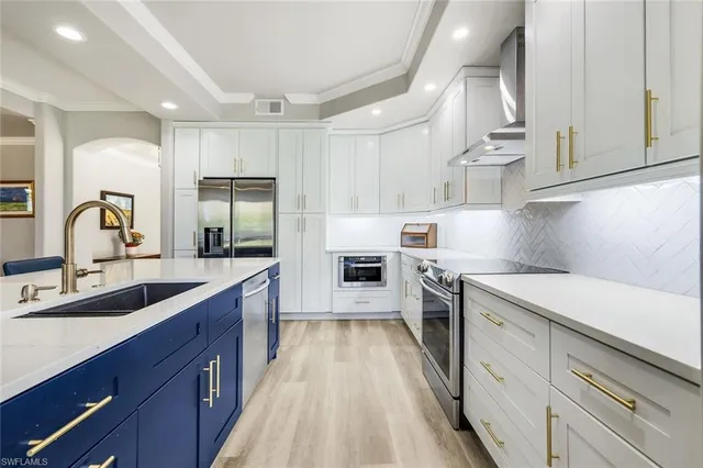 a kitchen with a sink cabinets and wooden floor