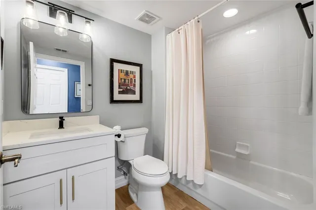 a bedroom with furniture and a painting on the wall