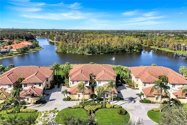 a view of multiple house with palm trees