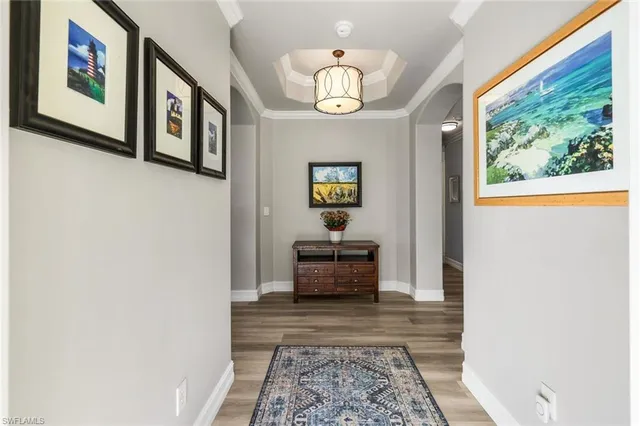 a living room with couches and a potted plant on table