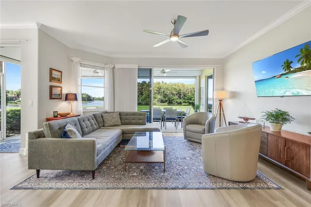 a living room with fireplace furniture and a window