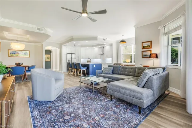 a view of a dining room with furniture and chandelier