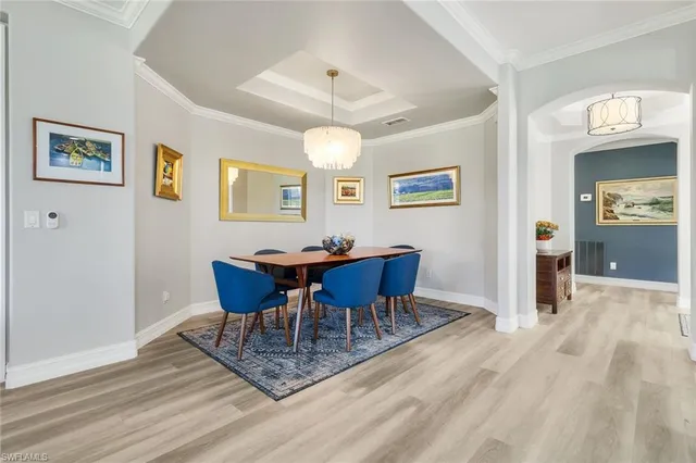 a dining hall with stainless steel appliances granite countertop a dining table and chairs