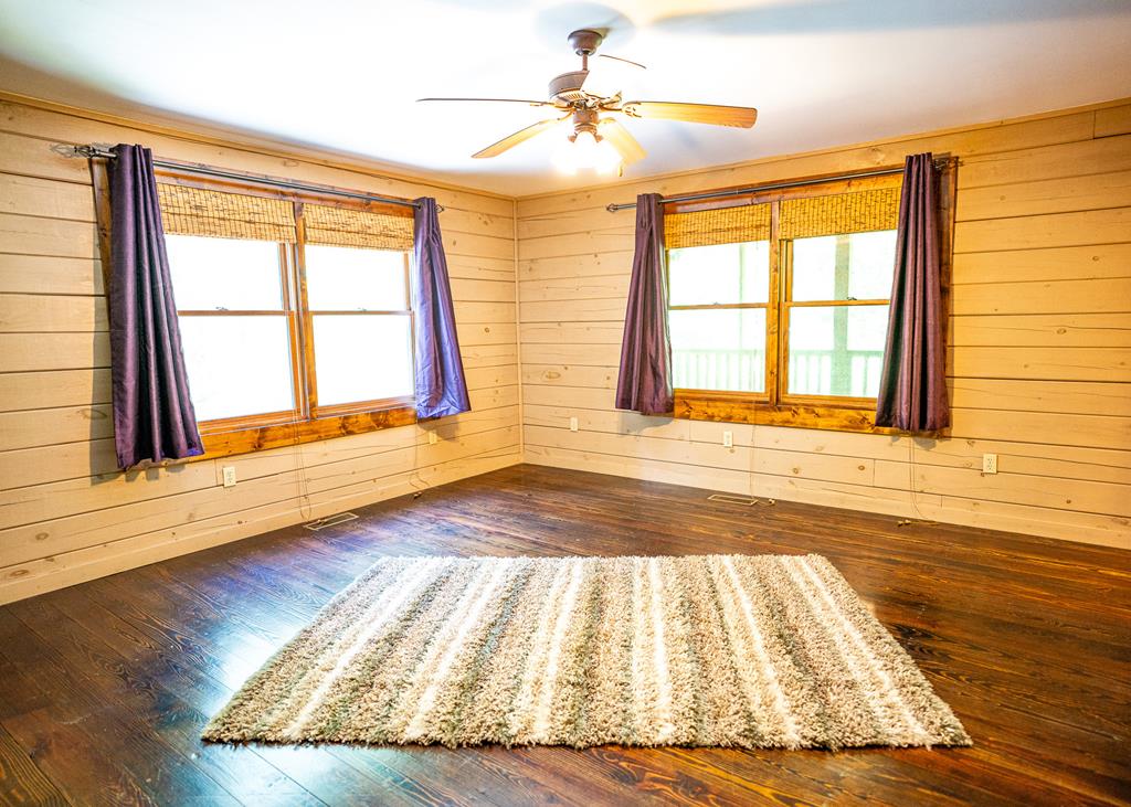 192 Fingerboard Road Reliance, TN 37369 - Photo 14 of 57 a view of an empty room with wooden floor and a window